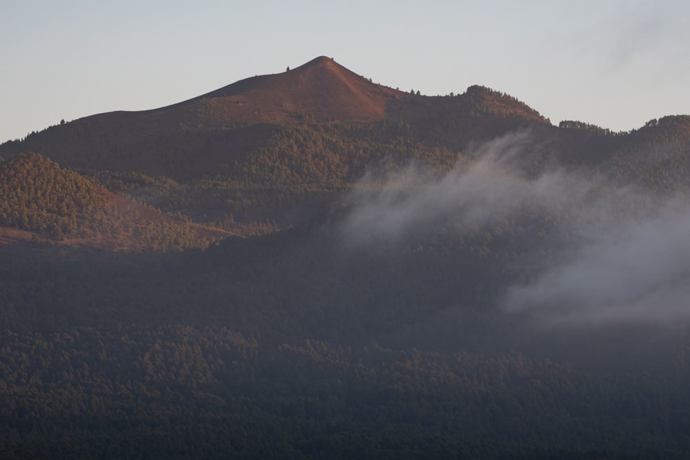 View of Pico Birigoyo just as the sun sets over the atlantic ocean lighting it from the right side