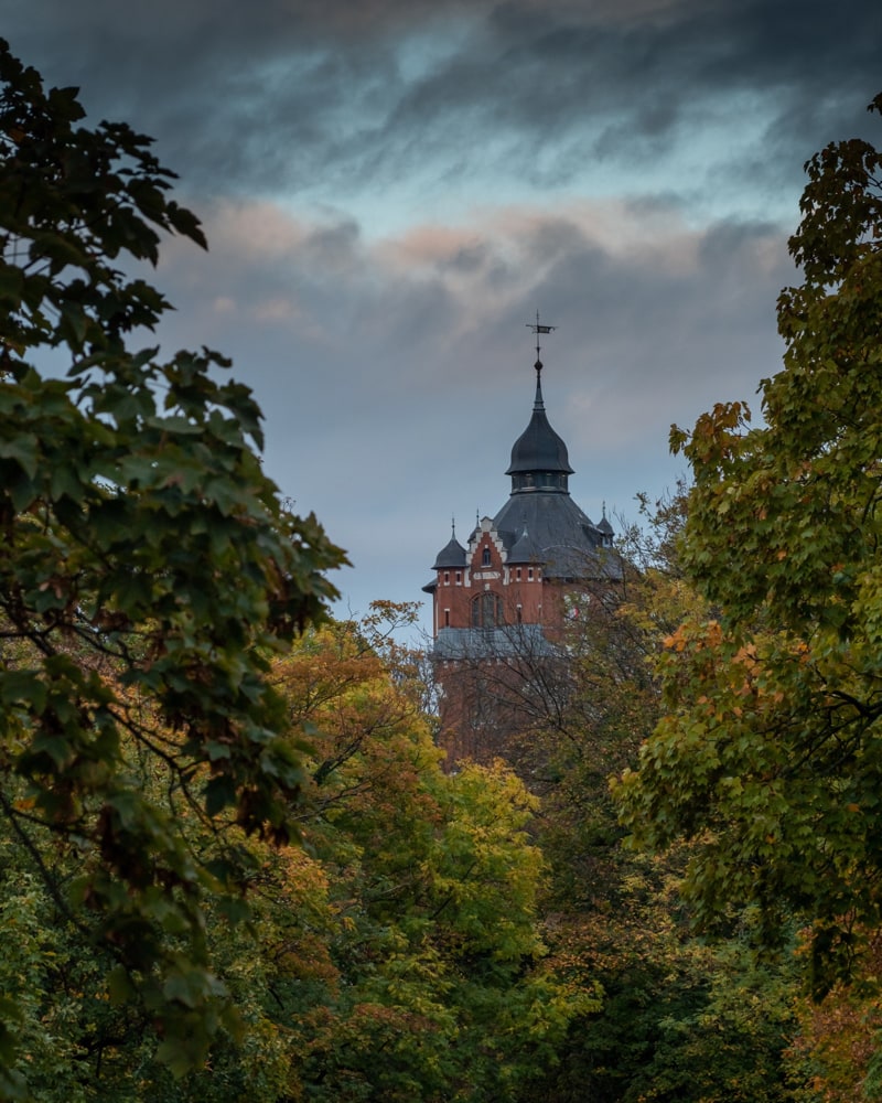 Stormy weather and colorful fall leaves in front of an old water tower