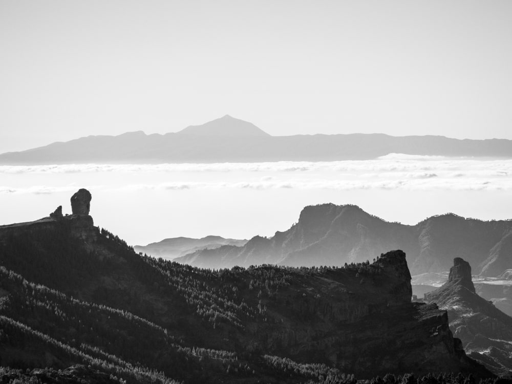 Black and white picture of Roque Nublo as seen from Pico de las Nieves, Roque Bentayga on the right and El Teide on Tenerife in the background roughly 120km from Gran Canaria