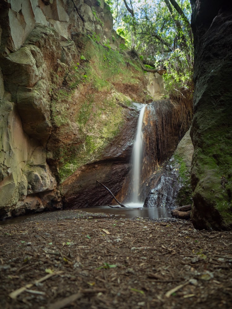 A long exposure photo of a small waterfall at the end of Barranco de los Cernicalos