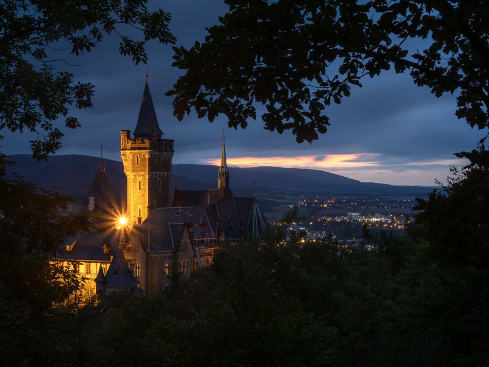 The castle of Wernigerode at blue hour against the last color of sunset in the sky in the background.