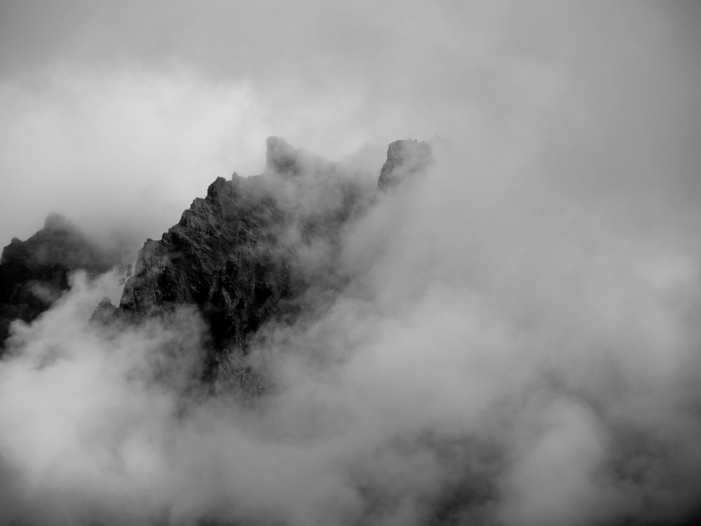 Black and white image of rocks being visible inside a cloud