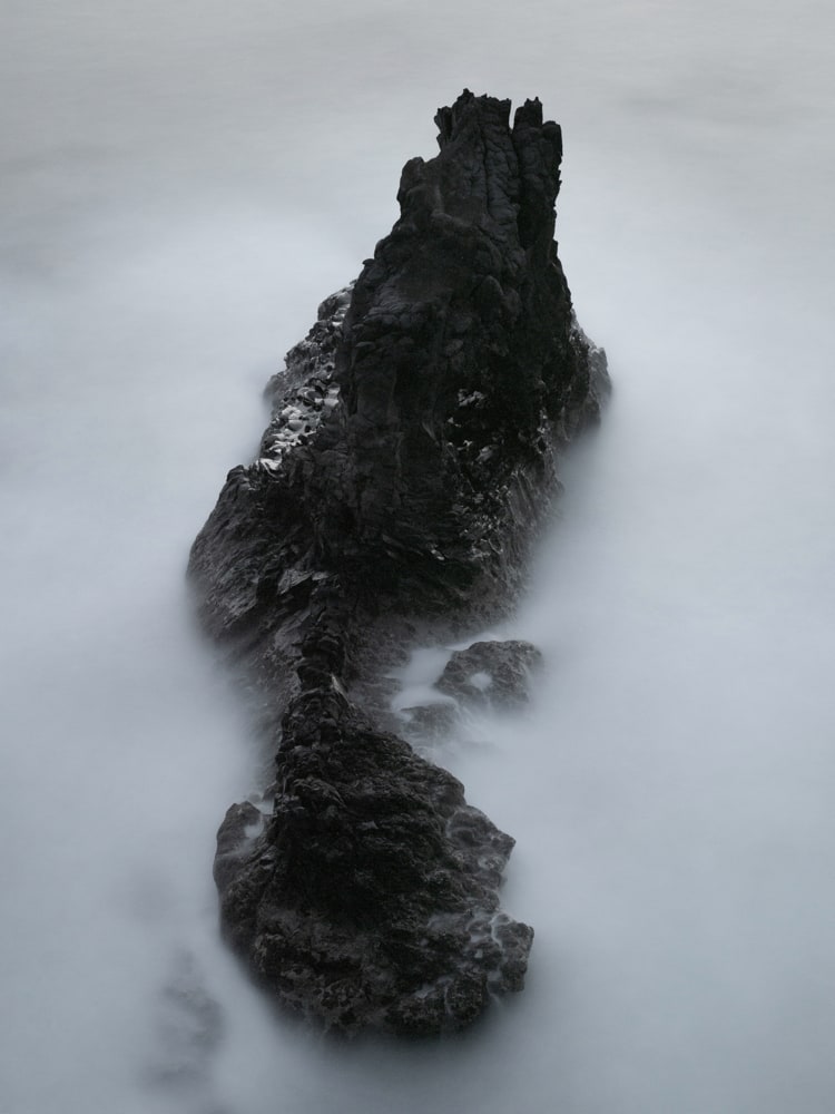 Black and white long exposure of a volcanic rock in the atlantic ocean