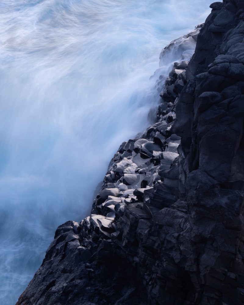 Detail long exposure shot of a volcanic rock in the atlantic ocean