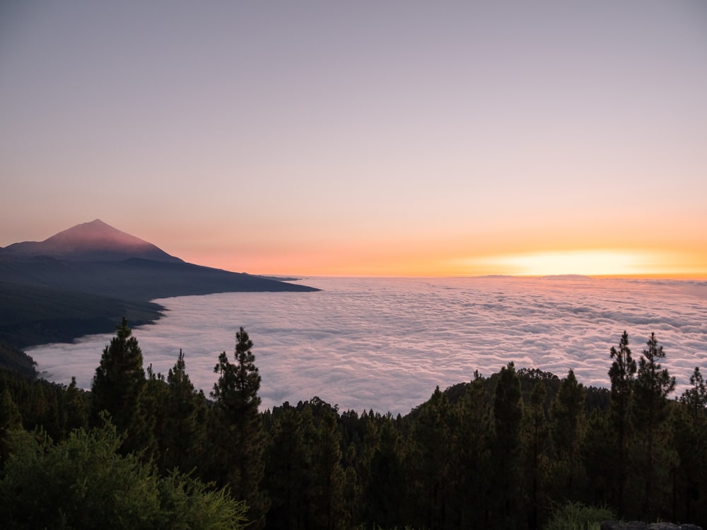 Sunset over La Palma seen from above the clouds over the Atlantic Ocean. The Teide is seen in the top left.