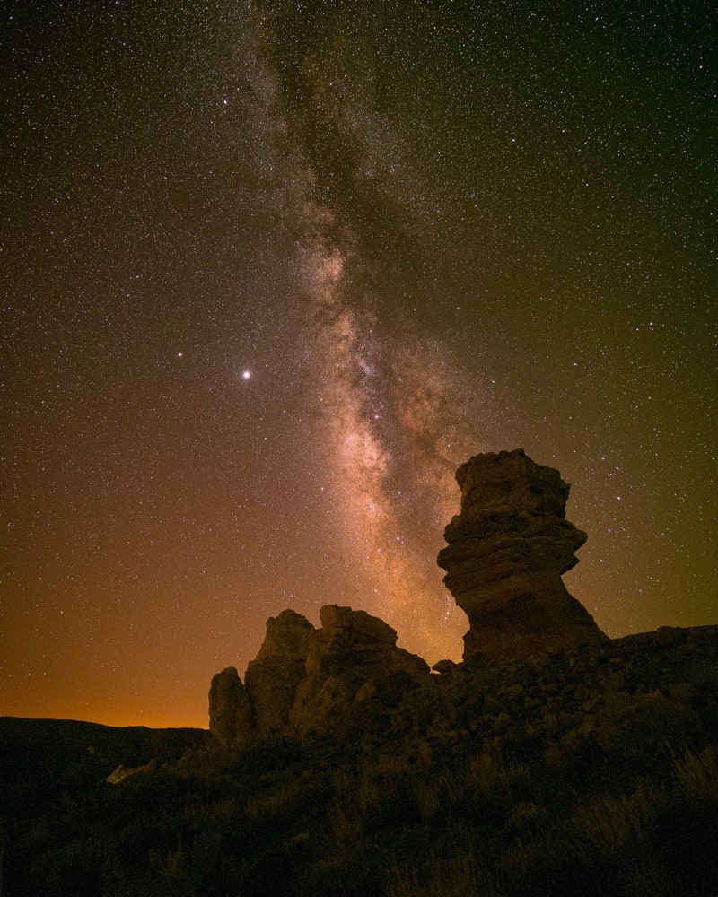 The milky way with the galactic core visible behind Roque Cinchado that is part of the rock formations of Roques de Garcia.