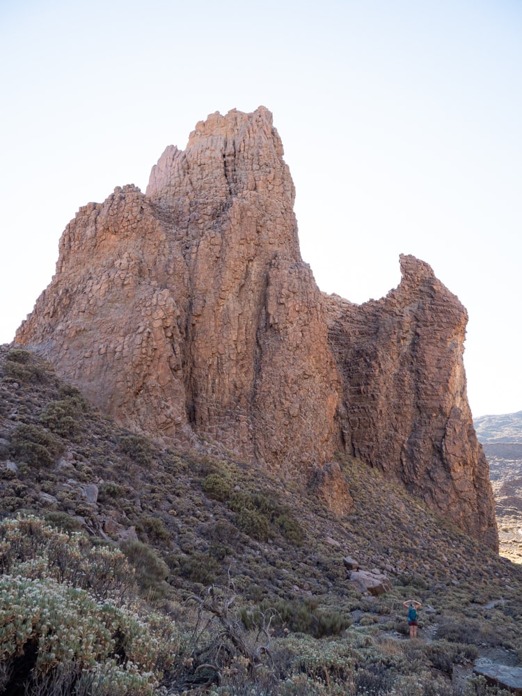 A rock formation called La Catedral backlit by the sun with my wife in the foreground.