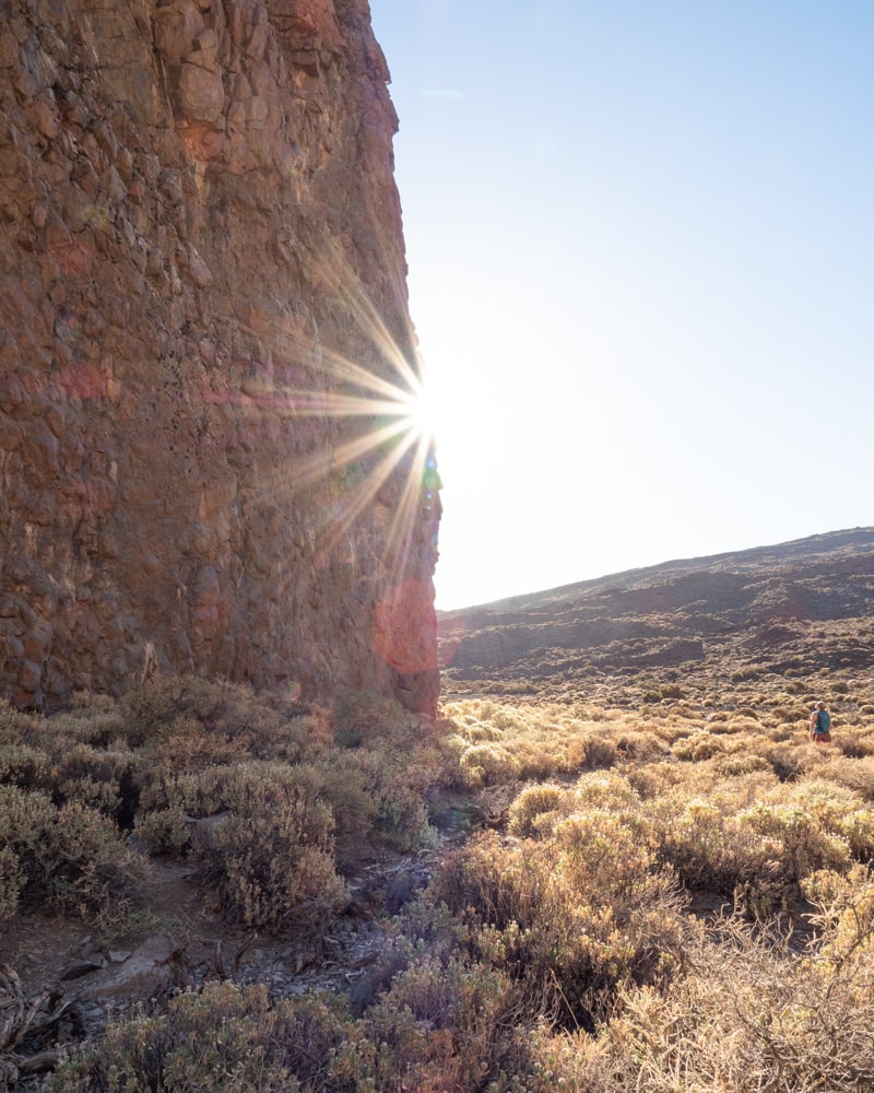 A sunstar forms on the site of a detail shot of La Catedral with my wife to the right of it.